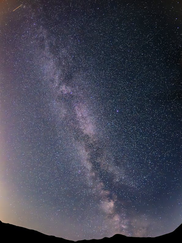 Home 22 The milky is seen in the sky above a mountain